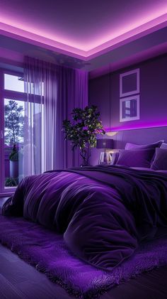 a bed with purple comforter and pillows in a room that is lit up at night