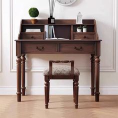 a wooden desk with a clock on the wall above it and a chair in front of it