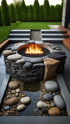 an outdoor fire pit with rocks and stones around it