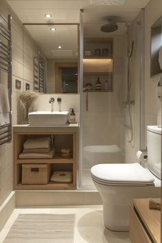 a bathroom with a toilet, sink, and shower stall is shown in this image