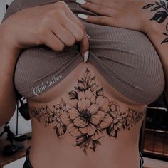 a woman's stomach with flowers on it and the words love written in cursive writing