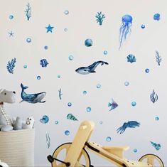 a child's room with an ocean theme wall decal and sea animals on the wall