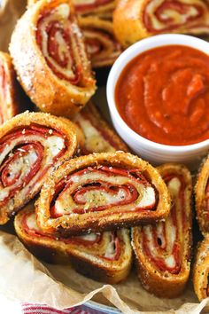 several pastries are arranged on a plate with dipping sauce