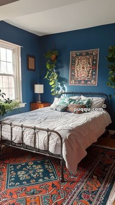 a bedroom with blue walls and rugs on the floor