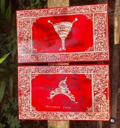 two red boxes with white designs on them