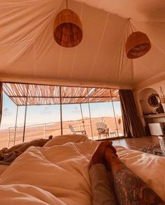 a person laying on top of a bed in a tent