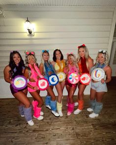 a group of women dressed in costumes posing for a photo