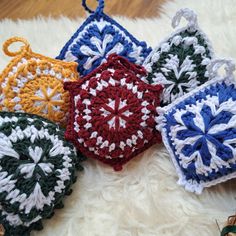 four crocheted ornaments sitting on top of a white rug