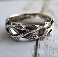 a silver ring sitting on top of a wooden table