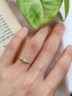 ✨ Dainty Light Green Jade Ring for Women ✨14K Gold Filled, Rose Gold Filled, Sterling Silver Wire Wrapped Tiny gemstone Ring💚 Simple stackable ring with a genuine green Jade, the good-luck stone. Jade is believed to bring protective, lucky-charm energy to the wearer 💚Sizing:• Gemstone Diameter: 4 mm• Ring Band: 0.8 mm • Handmade in your ring size with natural gemstone beads. • Dainty & cute. The ring is slim and petite, yet durable to wear daily. • Gold-filled is known for its lasting quality. Simple Ring With Stone, Daily Wear Rings For Women, Jade Rings For Women, Jade Engagement Ring, Natural Stone Rings, Green Jade Ring, Jade Rings, Handmade Gold Jewellery, Green Rings