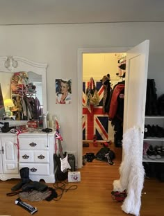 there is a closet with shoes and other items on the floor in front of it