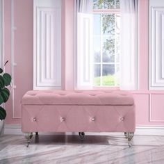 a pink bench sitting in front of a window