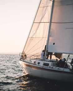 two people on a sailboat in the ocean