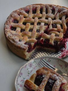 a pie with a slice missing from it sitting on a plate next to a fork