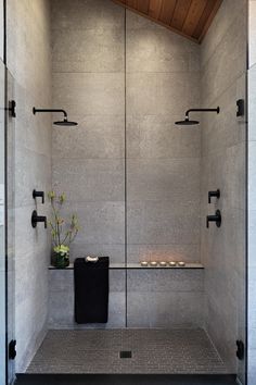 a white tiled shower with candles on the wall