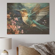 a painting of a hummingbird sitting on top of a bed next to a lamp