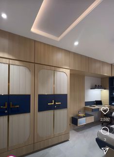 the interior of a modern apartment with blue and beige accents, including sliding doors that lead to an office area