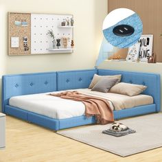 a blue couch with pillows and blankets on it next to a white bed in a room