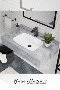 a white sink sitting under a mirror in a bathroom