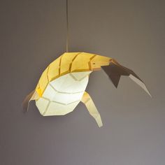 a light fixture made out of paper with a fish on it