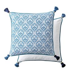 two blue and white pillows with tassels