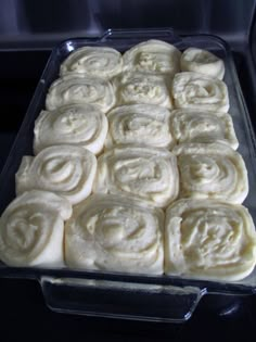 a pan filled with rolls sitting on top of a stove