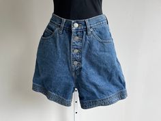 Great denim shorts with a button tab from the 1980's was made by "Honors" in the USA. They are marked a size 4, though of course please check the measurements given below to ensure a proper fit. They are in great condition and have been gently laundered. Measurements 4" inseam 25" waist 14" long 35" hips 12" rise Retro High-rise Jean Shorts With Pockets, Vintage Blue Short-length Jeans, Vintage High-waisted Shorts Jeans In Medium Wash, 90s Denim Blue Shorts With Pockets, 90s High-waist Cotton Jean Shorts, 80s Denim, Skorts, Light Wash Jeans, Short En Jean