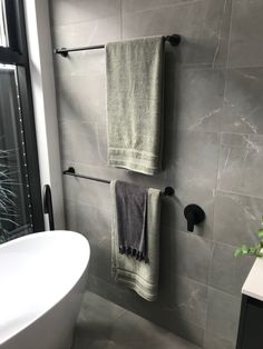 a bathroom with two towels hanging on the wall