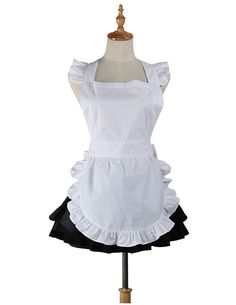 a white apron dress with black ruffles on the front and bottom, sitting on a mannequin