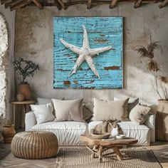 a living room filled with furniture and a starfish painting on the wall above it