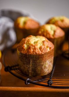 muffins cooling on a wire rack next to lemons