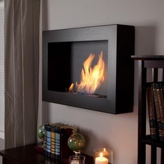 a living room with a fire place on the wall next to a book shelf and window