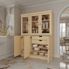 an open cabinet in the middle of a kitchen with marble flooring and white walls