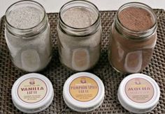 four jars filled with different types of food on top of a woven table cloth next to each other