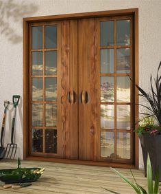 a wooden door sitting next to a potted plant