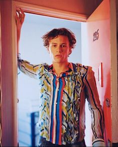 a young man standing in front of a doorway