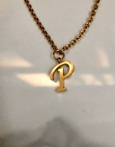 Letter P necklace, set on a stainless steel ,golden color chain. Chain length 19'  With addition cost there is an option to add a white freshwater pearl, as a charm, next to the letter. 6 mm, white round pearl Kindly choose your option. Beautiful spiritual gift. Please make sure you to pay attention to the size of the pendant. I have added pictures next to 25 cent coin, and measurement tape.  Need a different length just write it to me in the "message to the seller" box of the order form. **LIMI Initial Necklace P, P Necklace Letter, P Letter Pendant, P Necklace, Gold Dainty Stainless Steel Name Necklace, Dainty Gold Stainless Steel Name Necklace, Dainty Pearl Necklace, Hand Work Blouse Design, Cool Piercings