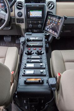 there is a control panel in the center of this vehicle's dashboard, with two phones on it