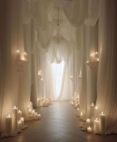 a white wedding ceremony with candles and drapes