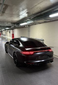 a black car parked in a parking garage