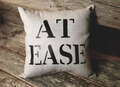 a pillow that says at ease on it