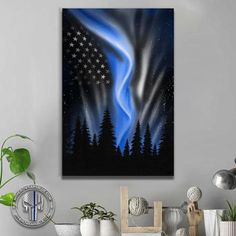 an abstract painting with stars and the aurora bore on it's side in front of some potted plants