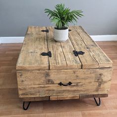 a wooden table with two drawers and a potted plant on top