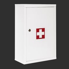 a white medicine cabinet with a red cross on the front and bottom panel, against a black background