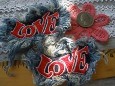 two pieces of fabric with the word love on them