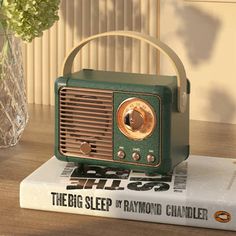 an old fashioned radio sitting on top of a book