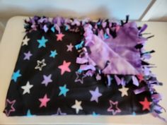 a blanket with purple and blue stars on it