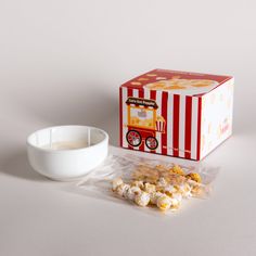 a box of popcorn next to a bowl of milk