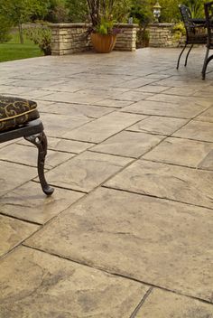 a bench sitting on top of a stone patio