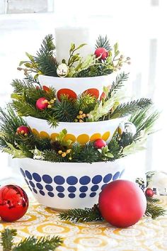 three bowls are stacked on top of each other with christmas decorations in the bottom tier